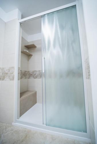 a shower with a glass door in a bathroom at Il Galante B&B casa vacanza in Ginosa
