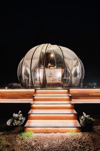 a glass dome on top of a set of stairs at Il Cantico Bubble Room Experience in San Giacomo