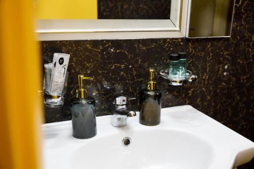 a bathroom sink with two bottles on top of it at Bora Hotel in Gjirokastër