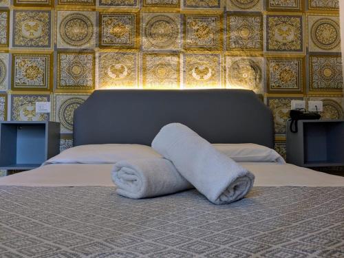 a bedroom with a bed with towels on it at Hotel Soggiorno Athena in Pisa