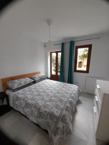 a bedroom with a large bed and a window at LA OLA Tarifa in Tarifa