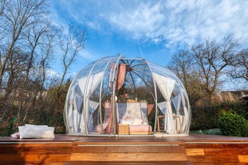 a glass dome with a bed in it on a table at Il Cantico Bubble Room Experience in San Giacomo