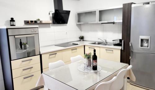 a kitchen with a table with two bottles of wine at Apartman Lucy in Split