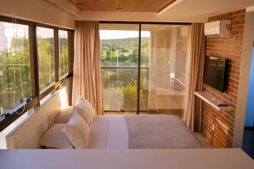 Cama ou camas em um quarto em Reserva Madero Loft Natal Hotel