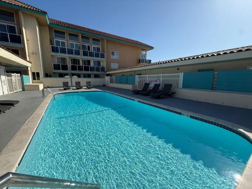 a swimming pool in front of a building at Oceanfront 2 BR w Pool & Parking 234 in Hermosa Beach