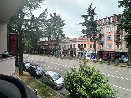 a street with cars parked on the side of the road at batummetropol hotel in Batumi