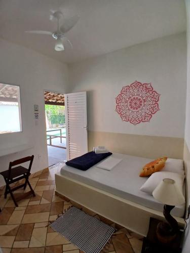 a bedroom with a large bed and a chair at Suítes Serra do Cipó 2 in Santana do Riacho