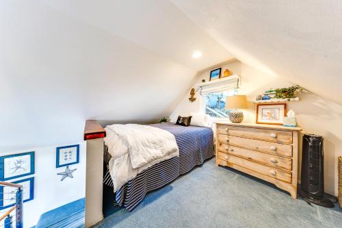 a bedroom with a bed and a dresser in a attic at Waterfront Gem with 2 Patios on Camano Island in Camano
