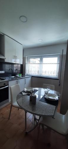a kitchen with a table and a table and chairs at Buarcos Beach House in Buarcos