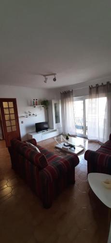 a living room with a couch and a table at Buarcos Beach House in Buarcos