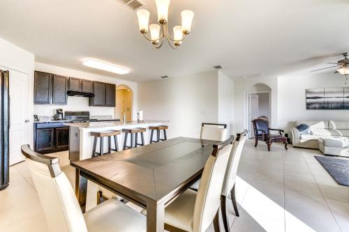 a dining room and kitchen with a table and chairs at 7 Mi to USTA Waterfront Tennis House with Yard! in Kissimmee