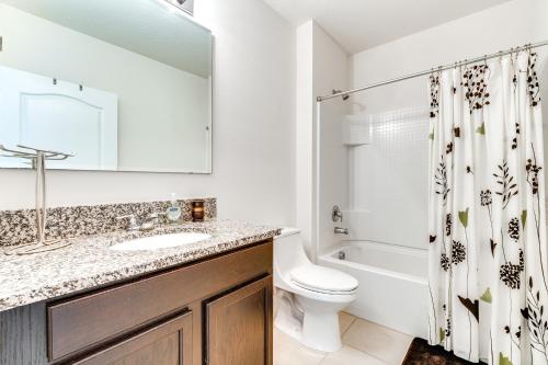 a bathroom with a sink and a toilet and a shower at 7 Mi to USTA Waterfront Tennis House with Yard! in Kissimmee