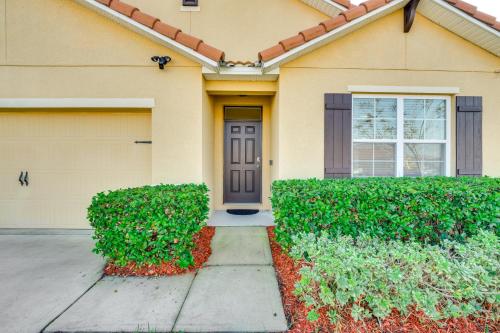 a house with a door and bushes in front of it at 7 Mi to USTA Waterfront Tennis House with Yard! in Kissimmee