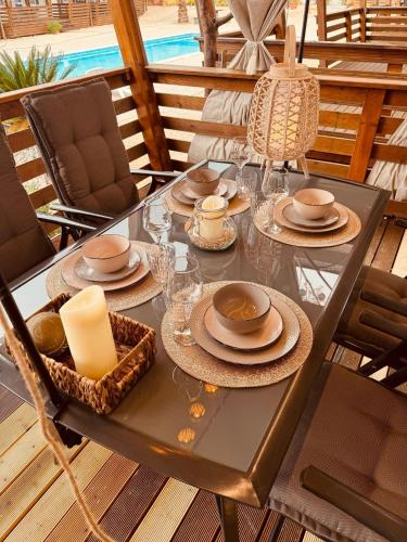 a table with plates and candles on a patio at Casabella Turanj in Turanj
