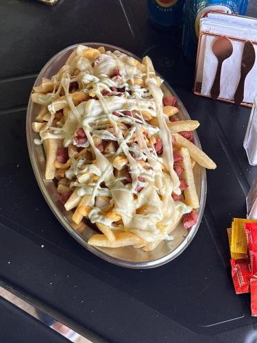 a plate of french fries on a table at Pousada Aconchego de Maricá in Maricá