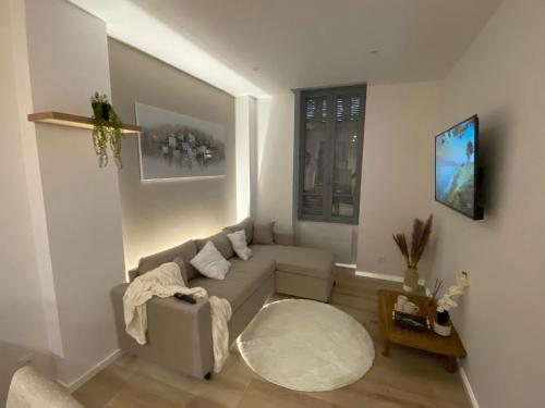 una sala de estar con un sofá y una mesa en La Douce Escale Hyper centre, en Carcassonne