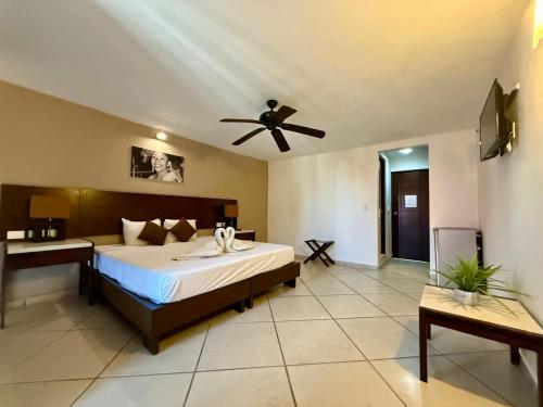 a bedroom with a bed and a ceiling fan at MULUC Playa in Playa del Carmen