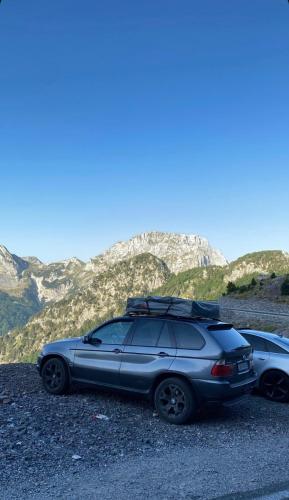two cars parked on the side of a mountain at lodi campers rental in Theth