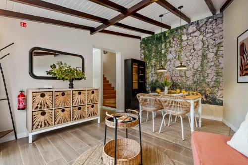 a dining room with a table and chairs and a mirror at Villa Monte in Funchal