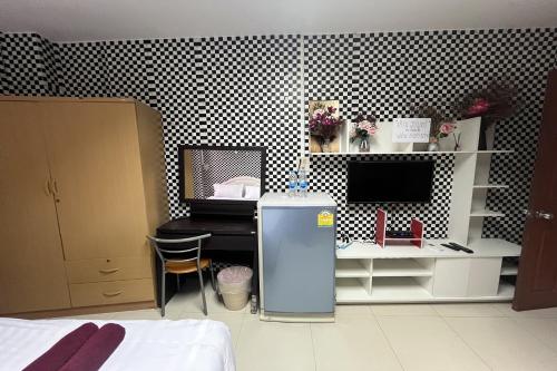 a room with a desk and a computer on a wall at Green Place 107 in Bangkok