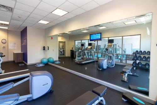 a gym with cardio equipment and a large mirror at Holiday Inn Express Leland - Wilmington Area by IHG in Leland