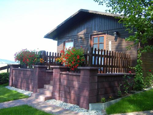 a small house with a fence in front of it at Holiday home by the forest in Olbernhau