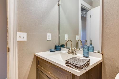 a bathroom with a sink and a mirror at Close to Town and Med Center Weslaco Home in Weslaco