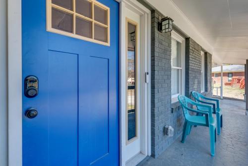 a blue door with two blue chairs on a porch at 11 Mi to Dtwn Atlanta Conley Home with Yard in Conley
