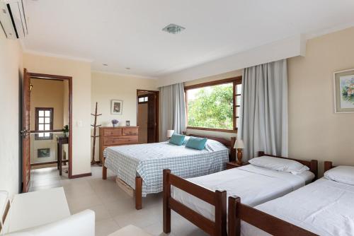 En eller flere senge i et værelse på Casa de campo em Gravatá, agradável e aconchegante