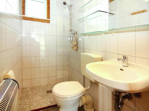 a white bathroom with a toilet and a sink at Holiday Park Markgrafenheide Markgrafenheide in Markgrafenheide