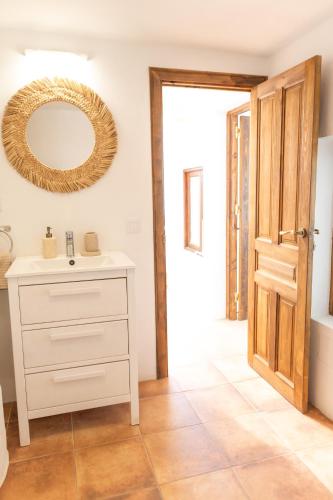a bathroom with a sink and a mirror on the wall at Charming house with Rooftop Pool in Agaete