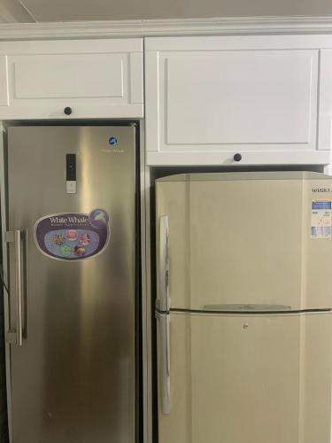 a stainless steel refrigerator with a sticker on it at H Flat With Roof- One Kattamya in Cairo