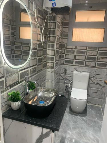 a bathroom with a sink and a toilet at H Flat With Roof- One Kattamya in Cairo