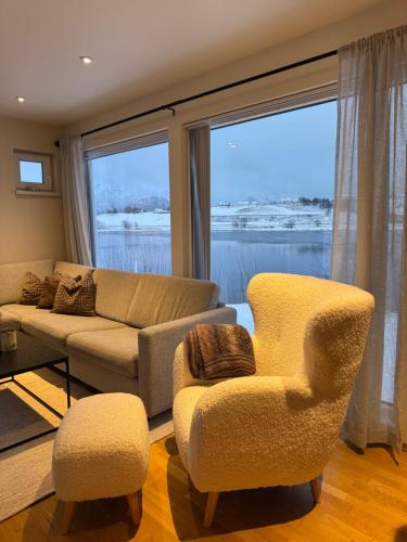 a living room with a couch and two chairs at Moderne Leilighet i Lofoten in Leknes