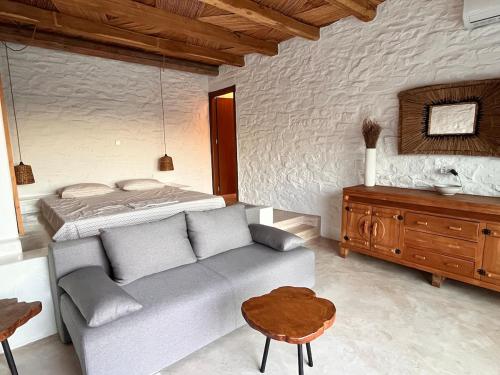 a living room with a couch and a bed at Kythnian Retreat in Kithnos