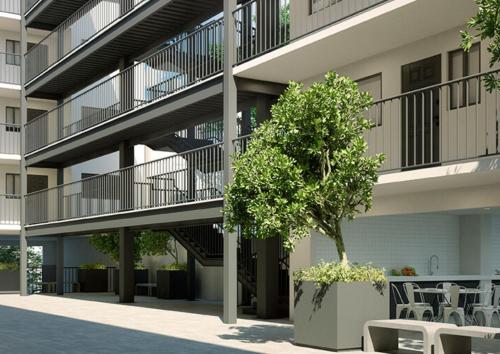 an apartment building with stairs and a tree in a courtyard at Lodging centrally located near H.Civil, CUCS, IMSS in Guadalajara
