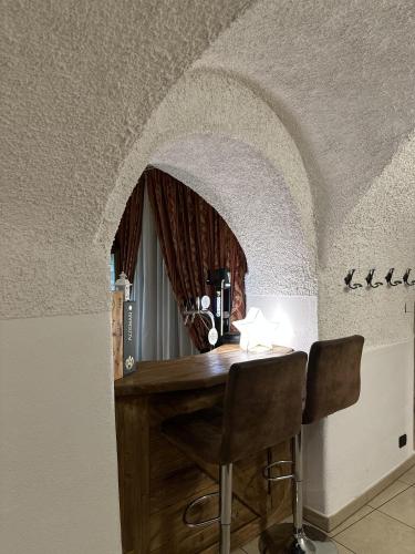 a room with a wooden table with a mirror at Folgaria Post Hotel in Folgaria