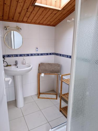 une salle de bain avec une douche, un lavabo et un miroir dans l'établissement Maison familiale à 600m de la plage 8mn à pieds, à Saint-Vincent-sur-Jard