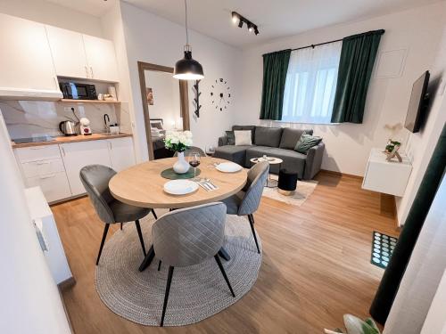 a kitchen and a living room with a table and chairs at Apartments BINGO - Zagreb airport in Velika Gorica