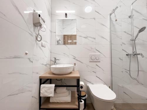 a bathroom with a toilet sink and a shower at Apartments BINGO - Zagreb airport in Velika Gorica