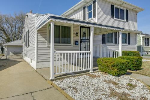 a white house with a porch and a door at 9 Mi to Dtwn Buffalo Family Escape with Fenced Yard in Cheektowaga