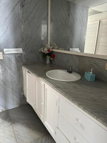 a bathroom with a white sink and a mirror at Laguito Suites Cartagena in Cartagena de Indias