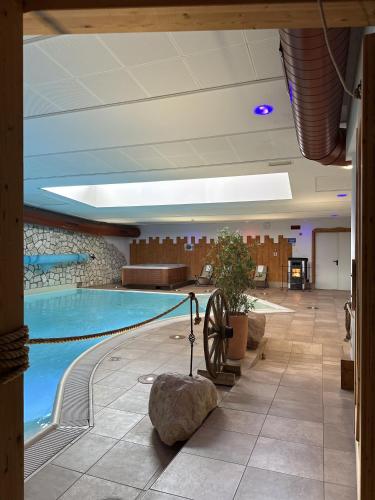 a swimming pool in a hotel lobby with a large pool at Folgaria Post Hotel in Folgaria