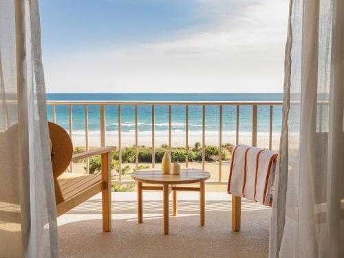 a balcony with a table and a view of the beach at Trailborn Surf & Sound, Outdoor Collection by Marriott Bonvoy in Wrightsville Beach