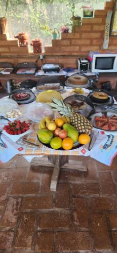 a table topped with lots of different types of food at Pousada Cheiro de Mato in Monte Alegre do Sul