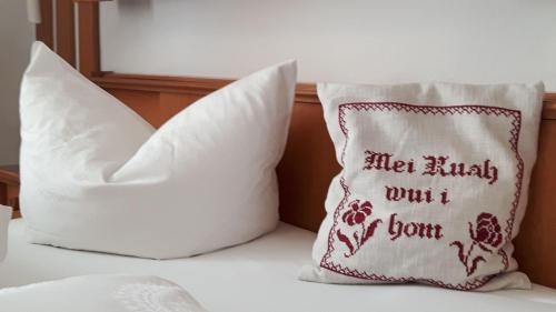 two pillows sitting on top of a bed at Gästehaus Annemarie in Reit im Winkl
