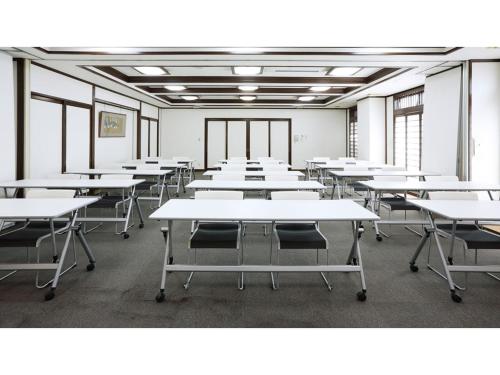 an empty classroom with white tables and chairs at Smile Hotel koriyama - Vacation STAY 61162v in Koriyama