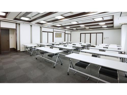 an empty classroom with white tables and chairs at Smile Hotel koriyama - Vacation STAY 61210v in Koriyama