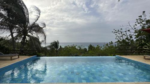 a swimming pool with a view of the ocean at Hotel Acantilado de La Tierra by On vacation in San Andrés