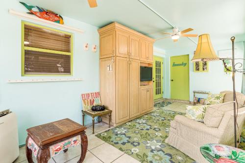 a living room with a couch and a tv at 4 Mi to Beaches Vibrant Stuart Villa with Patio! in Stuart
